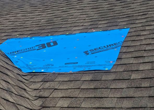 Smith Roofing and Restoration installing emergency roof tarp after storm in Jacksonville NC