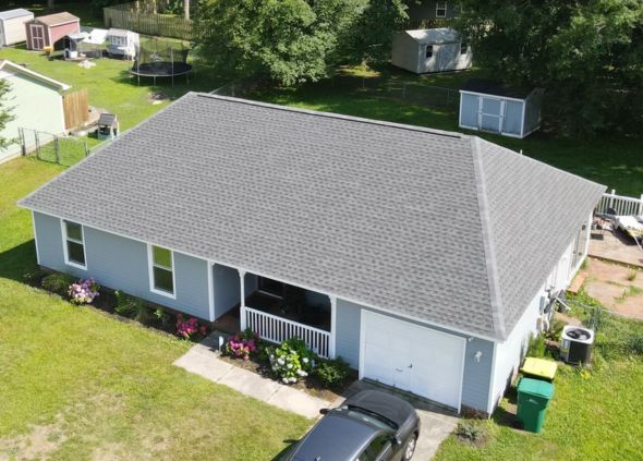 Brandon from Smith Roofing inspecting a storm-damaged roof in New Bern NC
